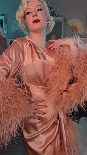 Catherine D'Lish on Instagram: "Now Shipping! Gorgeousness of @missaudreymonroe in our newest “Selene” dressing gown. Available in sizes XS-3X. Repost @missaudreymonroe This will be my forever haunting outfit. Unboxing the newest @Catherinedlish dressing gown ‘Selene’ in the color Femme. | Ad The second I opened the box, I knew... that if Jean Harlow were alive she would wear this. This dressing gown is dramatic, trimmed in ostrich feathers, rose gold and dangerously glamorous. Catherine D’Lish