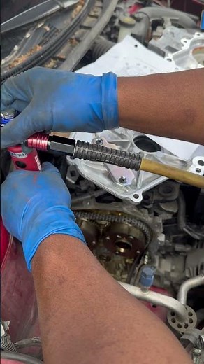 Installing timing chain guide bolts Nissan 1.8 L with Aircat 1/4 dr long neck, air ratchet