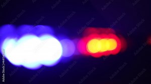 Lens flares from a police car flashers. Red and blue light flash. Concept of crime and arrest. Flares bokeh footage