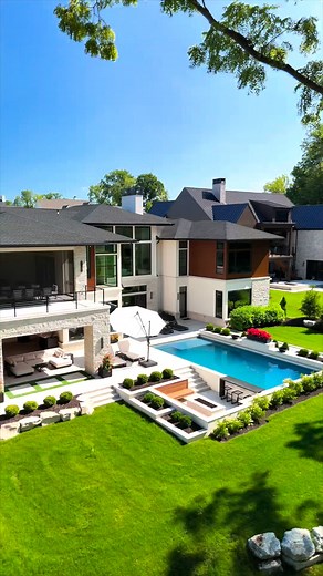 This landscape design makes the entire backyard feel organized and complete. The green lawn and garden beds create a calm setting around the pool. The outdoor seating, steps, and pathways all connect naturally, making this backyard feel like its own private outdoor space built to match the home perfectly. #backyarddesign #outdoorliving #outdoorlivingspace #landscaper #landscapingdesign #backyardlandscaping #landscapedesign #dreamhome #backyardgoals | P.J.E. Lawn Care & Landscaping