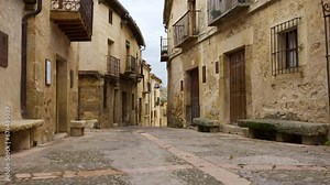 Picturesque alley in the medieval town of Segovia built with stone, Pedraza, Spain