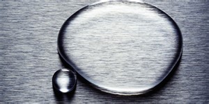 A Drop of Water and a Push Transfers 2-D Material Between Substrates