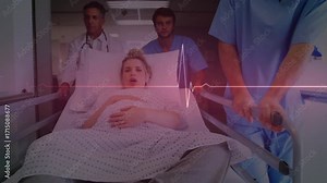 Nurses gripping handles and wheeling pregnant woman laboring on gurney while doctor monitoring ECG