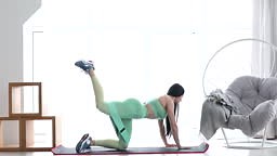 Fitness woman doing leg raises exercise for glute with resistance...
