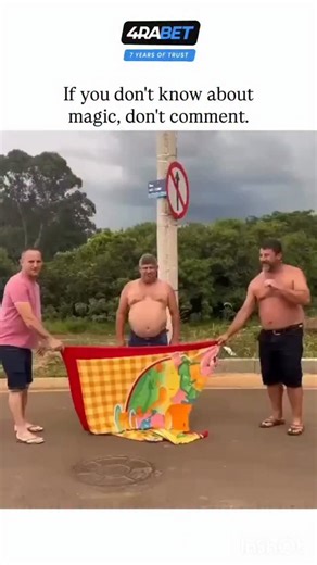 GLOBAL REEL HUB on Instagram: "This post features a 22-second video of a Brazilian street magic trick where three men hold a colorful beach towel in front of a lamppost, "disappearing" the middle man while his protruding belly creates a comical "pregnant lamppost" illusion, captioned sarcastically to deter uninformed comments. - Posted by @Rainmaker1973, known for curating awe-inspiring content on science and the unusual, the video exploded in popularity with 41k likes and 2.7 million views with