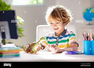 Online remote learning. School kids with computer having video conference chat with teacher and class group. Child coloring clay dinosaur. Arts Stock Photo - Alamy