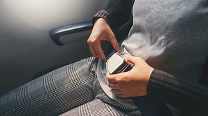 Is it illegal to not wear a seat belt on a plane when the light is on?