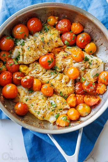 This simple Pan Seared Cod recipe features a classic white wine, tomato, and butter sauce that perfectly complements the flaky fish. Recipe: https://natashaskitchen.com/pan-seared-cod/ | NatashasKitchen.com