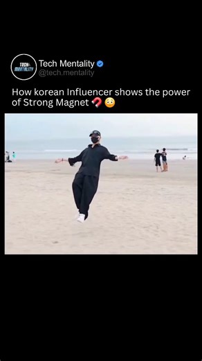 Tech Mentality on Instagram: "This Korean influencer turns a simple beach into a science spectacle with a powerful neodymium magnet. He poses dramatically as the magnet pulls magnetic black sand straight from the ground, creating an incredible visual effect that looks almost supernatural. The sand clings and swirls around the magnet, stunning onlookers and proving just how strong these magnets can be. It's a clever demo that blends entertainment with real physics—who knew sand could react like t