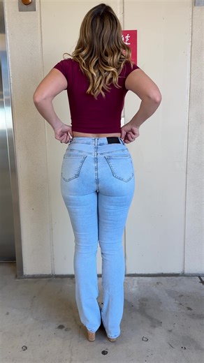 These jeans are my favorite right now! OK, yeah so for example, if you were posting this one, here’s what it could look like: Going down?? #denimrae #denim #bootcutjeans #elevator #jeans Outfit ideas | Jeans for hourglass figure | casual outfits Woman wearing light wash boot cut jeans and maroon crop top paired with wedge heels gets into an elevator.