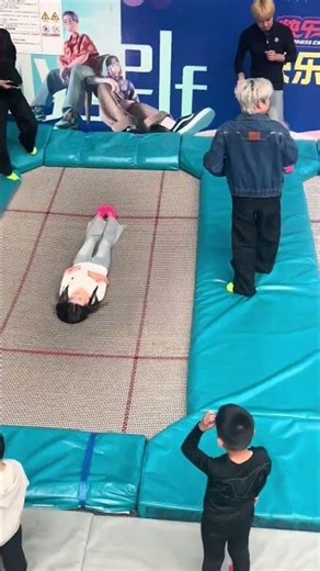 Woman lifted on trampoline in playful moment in Jilin, China