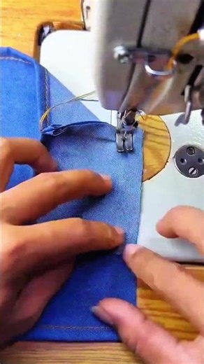 Blue fabric guides needle hums seam joins denim steady