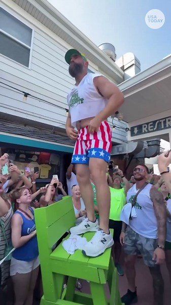 Watch as Jason Kelce rips off his patriotic shorts at an Eagles event