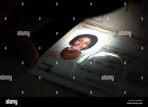A forged British passport is scanned by a video spectral comparator machine, which helps to identify forged passports Stock Photo - Alamy