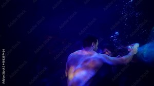 love of mermaid and human, loving couple is floating slowly in dark depth of sea or ocean