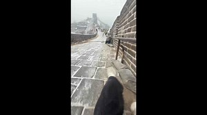 Visitors struggle to walk on slippery Great Wall path during icy weather in Beijing, China