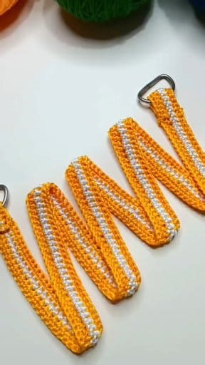 Easy Crochet Bag Holder Made this crochet bag holder in a clean stripe pattern. #crochetbagholder #crochetstrap #bagholder #hangingorganizer #handmadestrap #yarnbagholder #handmade #crochetlove #yarnlove #crochetwithsadhna | Crochet with Sadhna