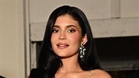 Kylie Jenner stepped out at the Schiaparelli show during Paris Fashion Week in an eye-catching silver gown complete with glittery fringe and a dramatic plunging neckline. bit.ly/4nxsy2m | E! News