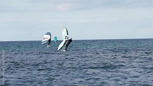 Modern water sport. Hydrofoil ride on the ocean using the wing and the power of the wind. the best place for kitesurfers, video of fit athlete practise hydro foil wing surfing