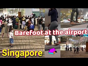 Barefoot at the airport of Singapore. The largest, cleanest, busiest and most entertaining airport.