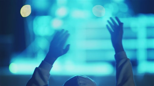 Hands clapping illuminated by concert lights - Free Stock Video