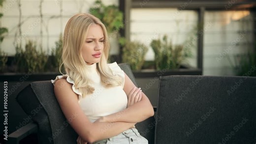 Frustrated young woman working on a laptop outdoors, typing intensely, getting angry and slamming the keyboard before closing the laptop. Stress, irritation and emotional work moment
