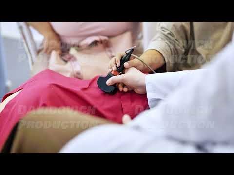 Doctor guiding patient using ultrasound machine for medical examination