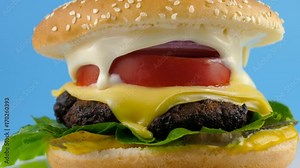 Fast Food Cheeseburger with grilled meat, ProRes codec, 422 HQ, blue background, ready for chroma key