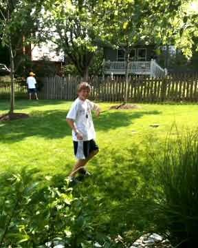 Weird guy peeing in a bush.