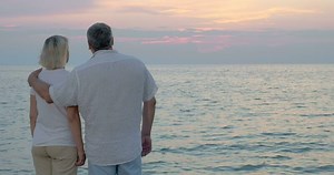 Loving senior couple enjoying evening seascape