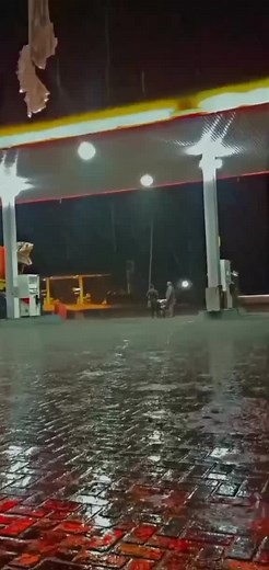 Nighttime Gas Station Scene with Truck and Attendants