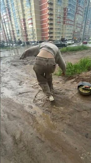 Teen slips and falls into mud while pushing scooter in Domodedovo, Russia