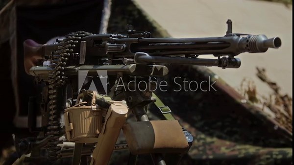 German MG42 Machine Gun with Ammunition belt on Tripod at World War II Reenactment. Close up of iconic WWII general-purpose weapon mounted for sustained fire. Wehrmacht Army firearm Military equipment