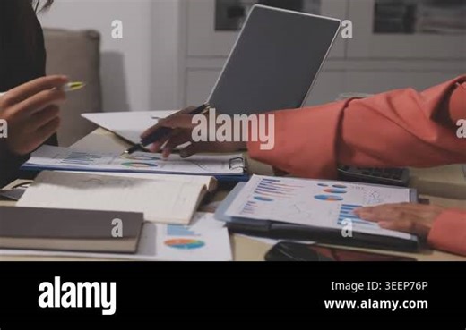 business woman working in office with financial graph on desk Stock Video Footage - Alamy