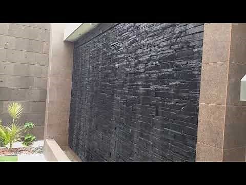 instalación de cantera y piedra prefabricada sobre muro lloron