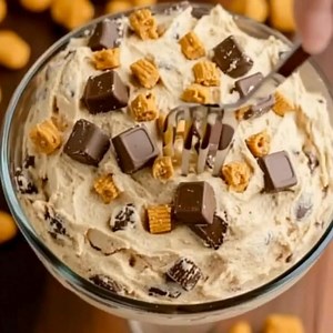 Reese's Peanut Butter Fluff Ingredients: 1 cup creamy peanut butter 1 cup powdered sugar 8 oz cream cheese, softened 1 tsp vanilla extract 8 oz Cool Whip (or any whipped topping) 1 cup mini Reese's peanut butter cups, chopped Directions: 1. In a large mixing bowl, combine the creamy peanut butter, powdered sugar, softened cream cheese, and vanilla extract. Mix until smooth and well combined. 2. Gently fold in the Cool Whip and chopped mini Reese's peanut butter cups until everything is evenly mi