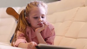 Little girl using a tablet.