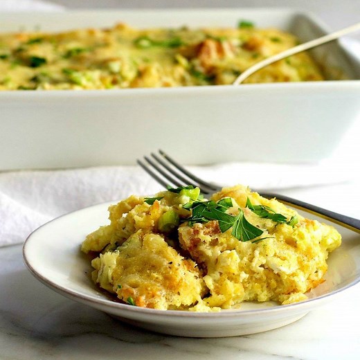 Cornbread Pudding is a delicious way to use up leftover skillet cornbread! Made with cheese, green onions and fresh herbs, it's lightly browned on the outside, delicate and custard-like in the center and so easy to make! Full Recipe: https://pinchandswirl.com/cornbread-pudding/ Pin for Later: https://www.pinterest.com/pin/119134352627380951/ | Pinch and Swirl
