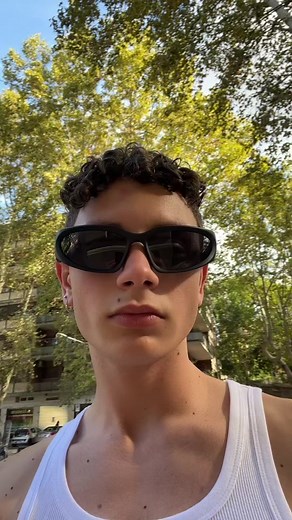 Young Male in Urban Setting Engaging with Passersby