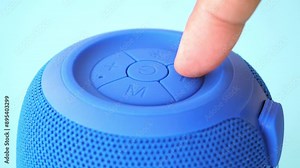 finger press the button to turn on smart speaker