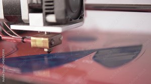 Shallow depth fof field Close up of a home made 3d printer working on a plastic face mask prototype design with filament diagonals