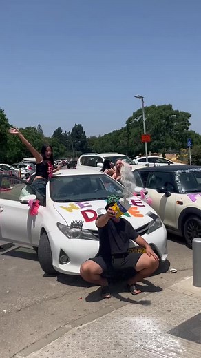 Celebratory Street Parade with Festively Decorated Cars