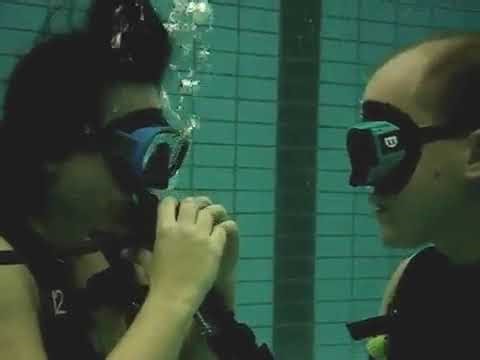Scuba Divers training underwater in pool