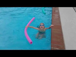 4. child swimming with pool noodle, supervised!