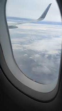 Plane Window View Flying Above Clouds | Aerial Travel Video