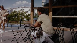 A young latino woman is welcoming a white man at the cafe