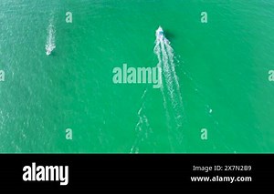 Small motorboat sailing fast on ocean waves with ripple water surface. Sailboat in motion on ocean in Florida.
