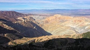 Aerial view of the Bingham Canyon mine in Utah looking towards Salt Lake City on sunny day.
