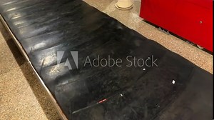 Airport luggage carousel. Baggage conveyor at an airport. Waiting for luggage at the airport baggage carousel.