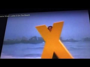 Sesame Street letter x on the beach